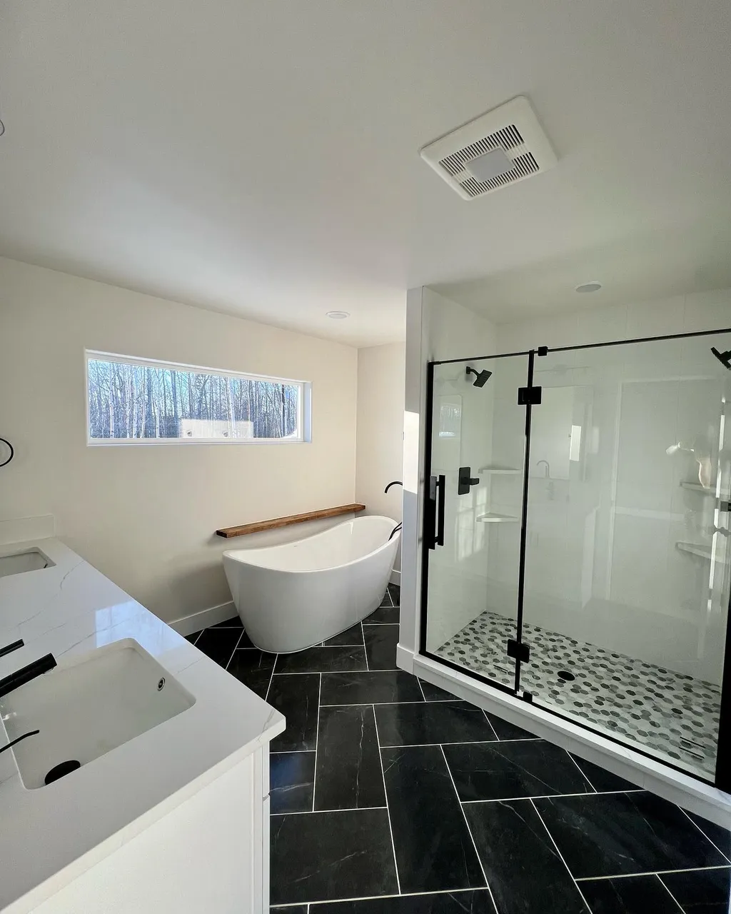 A beautiful living room with windows overlooking the mat-su valley.